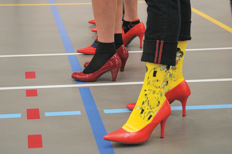 Men strap on heels to Walk A Mile In Her Shoes